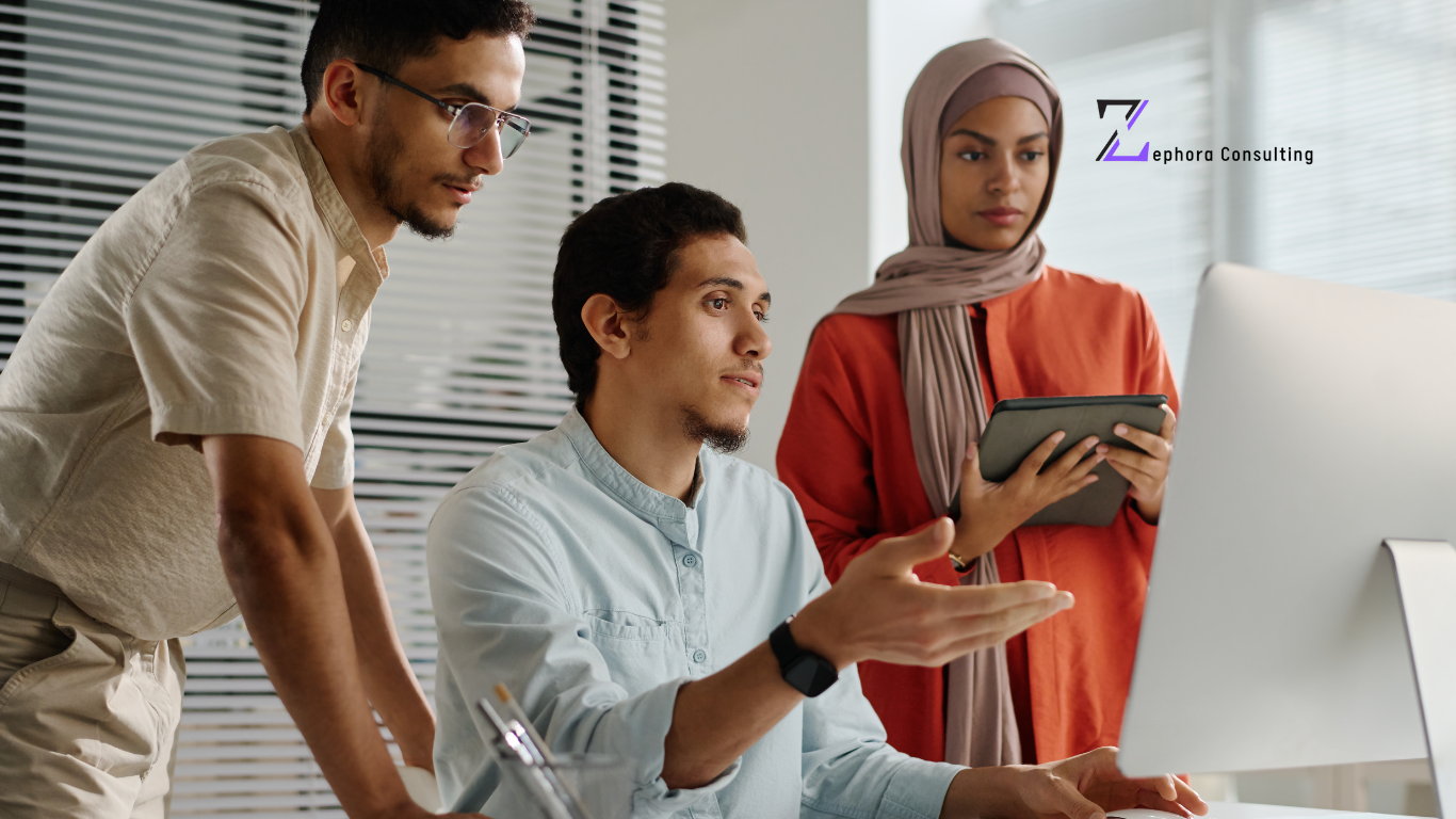 Three professionals, including a female holding pen and paper, collaborating on Top Employer of Record services in Dubai