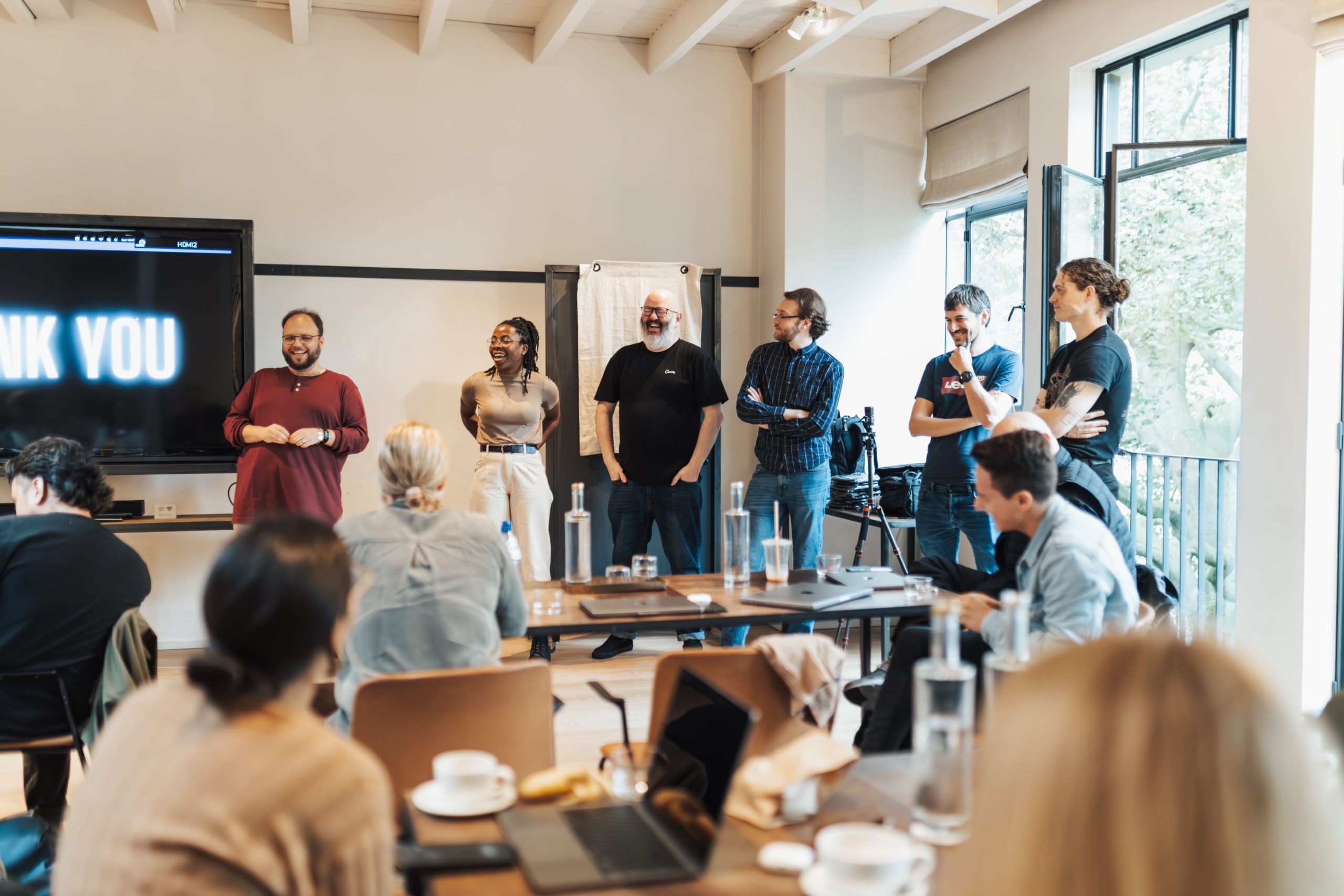 Professional team standing together after a completed training session with a “Thank You” message on the board, representing Sales Training & Coaching Services, team development, and successful learning outcomes.