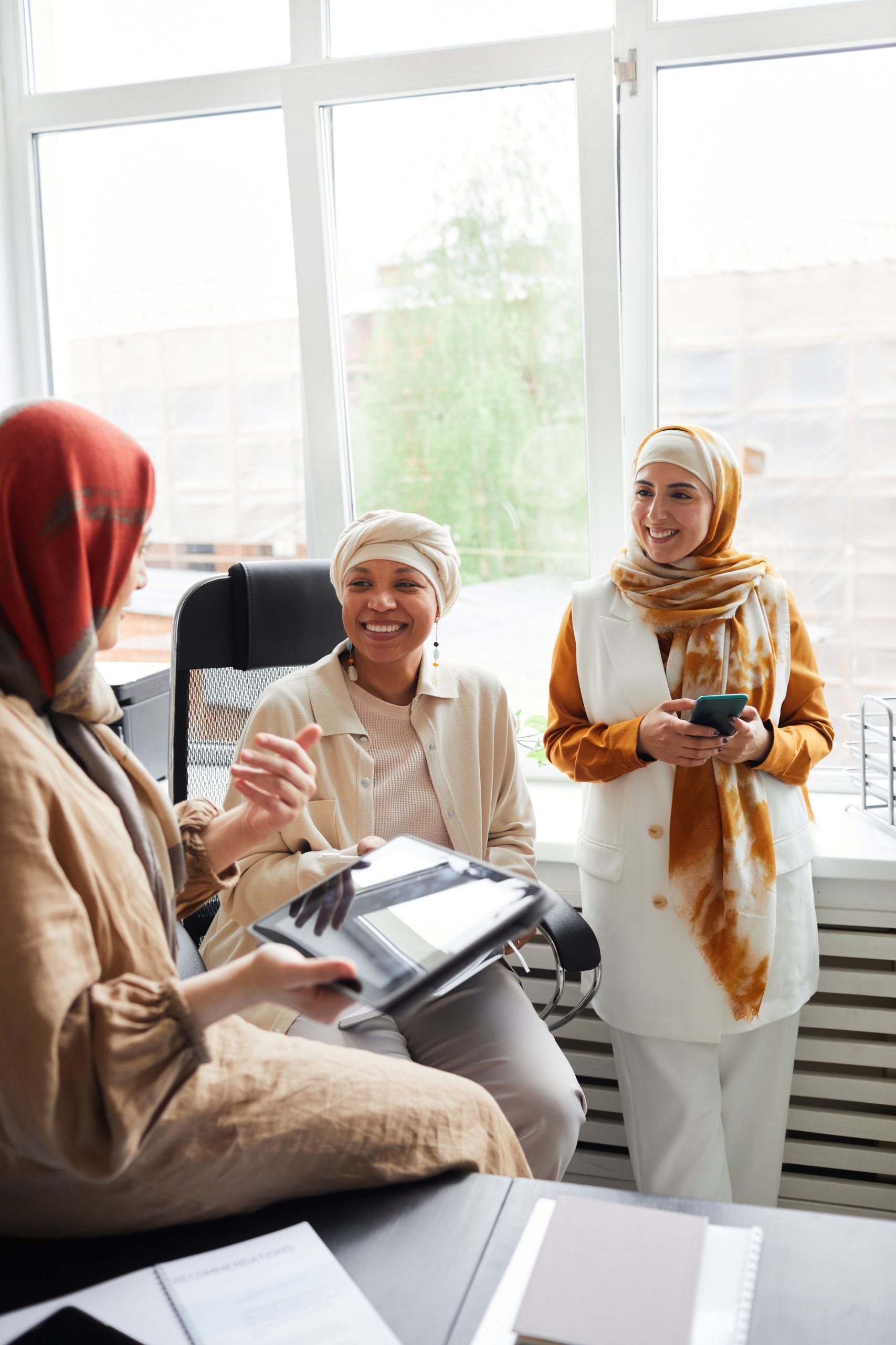 Digital marketing services team standing together and discussing strategy during a collaborative business meeting