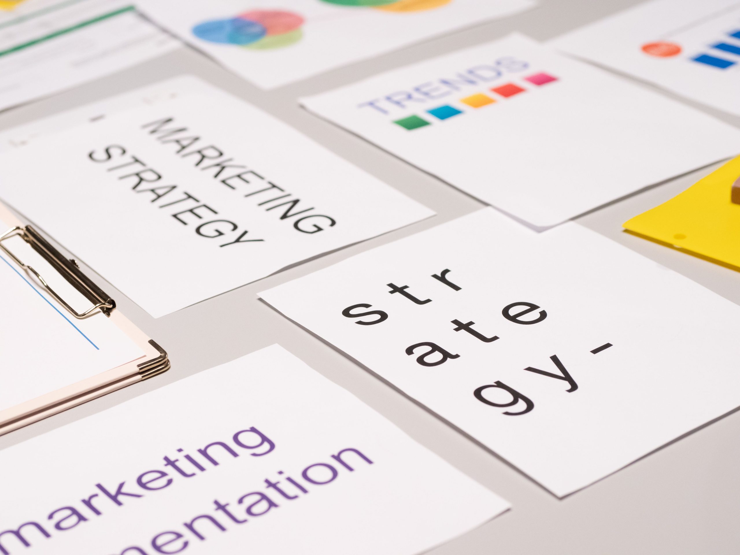 Marketing collateral design strategy documents, branding materials, and creative planning sheets arranged on a desk.
