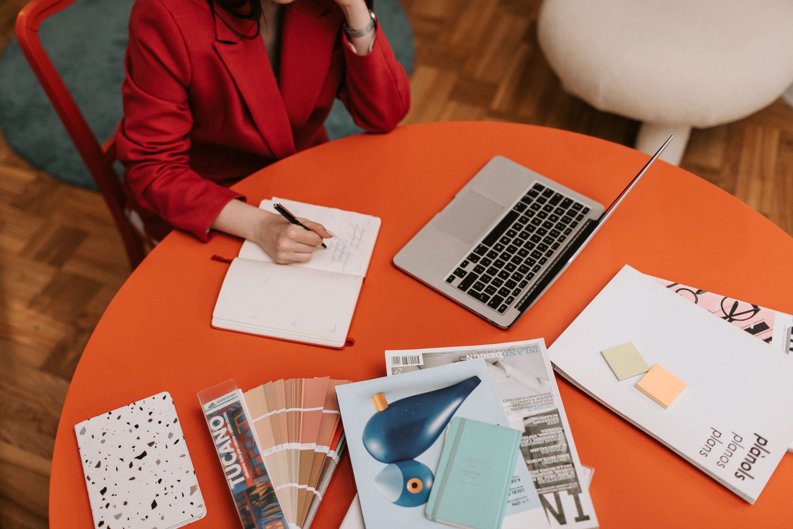 Corporate Branding Services in Dubai with a businesswoman discussing brand strategy on the phone while reviewing colour palettes and branding documents.