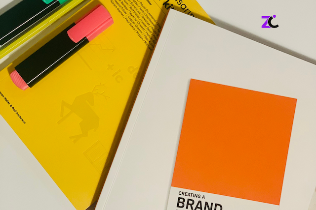 Corporate branding UAE featuring two highlighters, a brand book, and printed brand guidelines showcasing a cohesive visual identity.