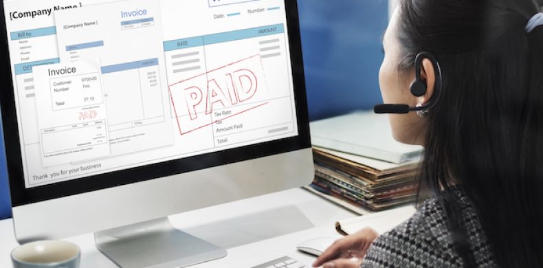 Woman working on e-invoice software on desktop for UAE e-invoicing consulting and implementation.